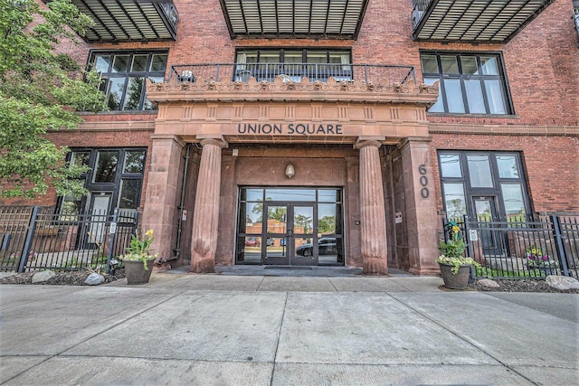 600 Broadway Ave NW Unit 402, Grand Rapids, MI 49504 - doorway to property with french doors and brick siding