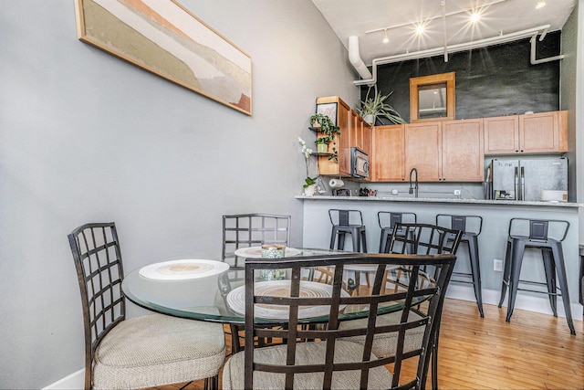 600 Broadway Ave NW Unit 402, Grand Rapids, MI 49504 - dining space featuring track lighting and light wood-type flooring