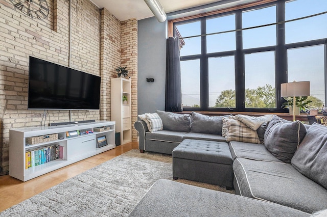 600 Broadway Ave NW Unit 402, Grand Rapids, MI 49504 - living area featuring brick wall, light wood finished floors, and a high ceiling