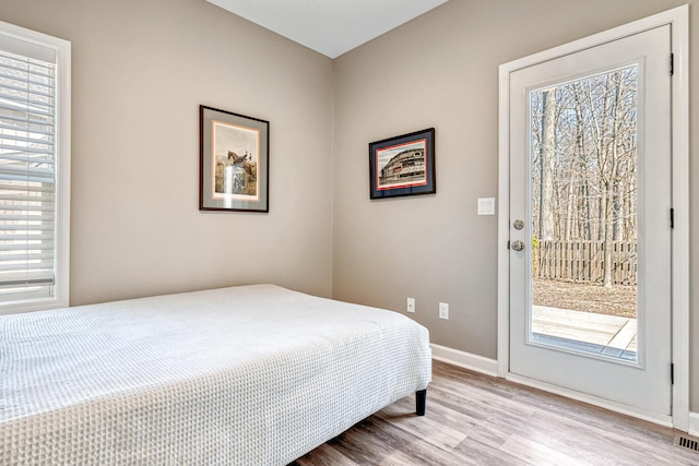 32 Walden Way, New Buffalo, MI 49117 - bedroom featuring access to outside, multiple windows, and wood finished floors