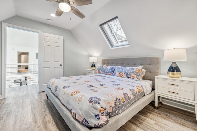 32 Walden Way, New Buffalo, MI 49117 - bedroom with vaulted ceiling, wood finished floors, a skylight, and ceiling fan