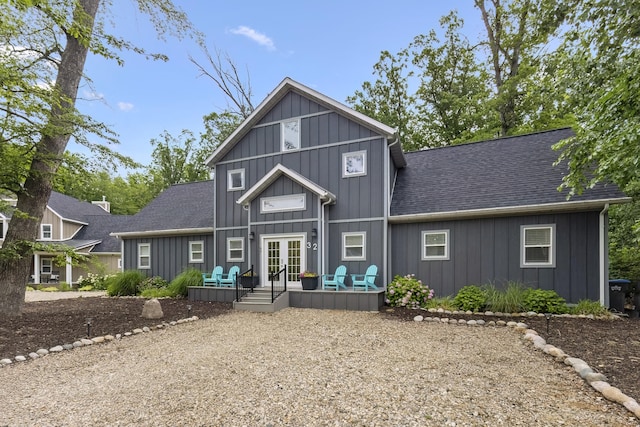 32 Walden Way, New Buffalo, MI 49117 - view of front of property featuring french doors, board and batten siding, a deck, and a shingled roof