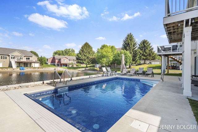 7066 Country Springs Dr SW, Byron Center, MI 49315 - outdoor pool featuring a patio, stairway, a water view, and a residential view