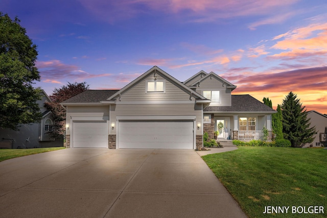 7066 Country Springs Dr SW, Byron Center, MI 49315 - view of front of property with an attached garage, a front lawn, driveway, covered porch, and stone siding