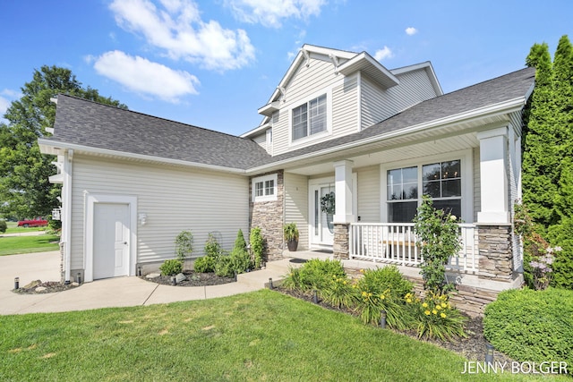 7066 Country Springs Dr SW, Byron Center, MI 49315 - view of front facade featuring a porch, a front lawn, stone siding, and a shingled roof