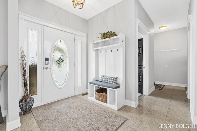 7066 Country Springs Dr SW, Byron Center, MI 49315 - mudroom with stacked washer and clothes dryer, granite tiled floors, and healthy amount of natural light