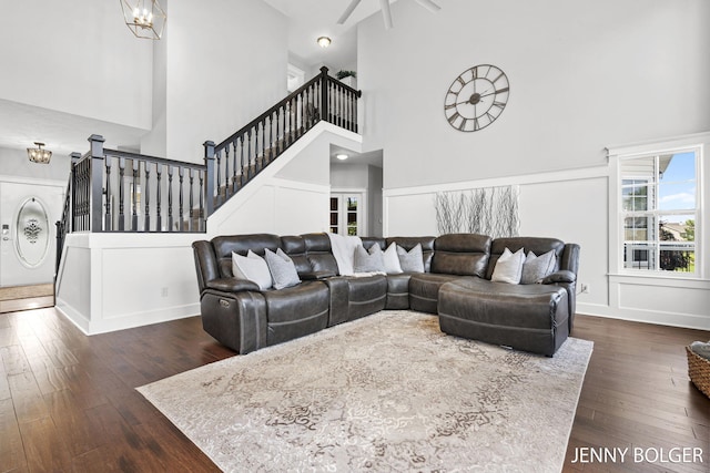 7066 Country Springs Dr SW, Byron Center, MI 49315 - living room with a high ceiling, wood finished floors, stairway, and a chandelier