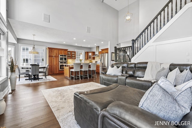 7066 Country Springs Dr SW, Byron Center, MI 49315 - living area with a towering ceiling, dark wood finished floors, stairway, and recessed lighting