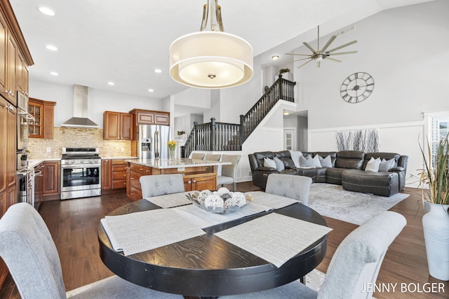 7066 Country Springs Dr SW, Byron Center, MI 49315 - dining space with a ceiling fan, high vaulted ceiling, stairs, dark wood-type flooring, and recessed lighting