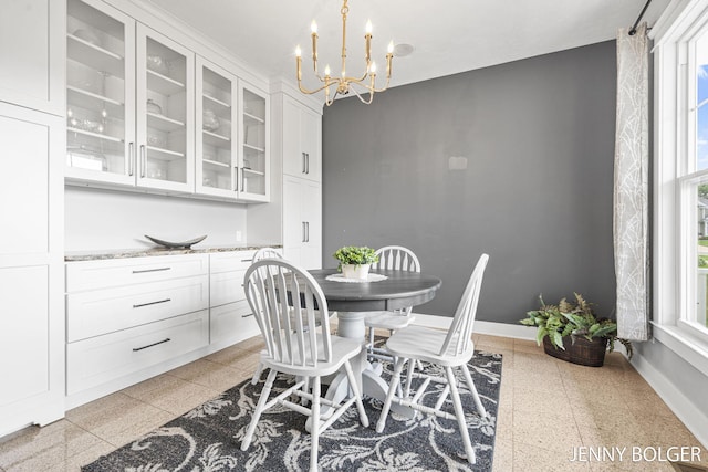 7066 Country Springs Dr SW, Byron Center, MI 49315 - dining room featuring dark aggregate flooring and a chandelier