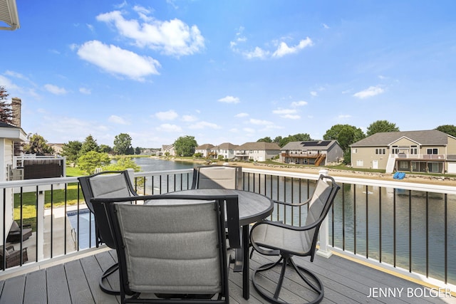 7066 Country Springs Dr SW, Byron Center, MI 49315 - deck with a residential view, a water view, and outdoor dining area