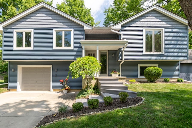 266 Westover Ave, Ann Arbor, MI 48103 - bi-level home with a front yard, an attached garage, and driveway