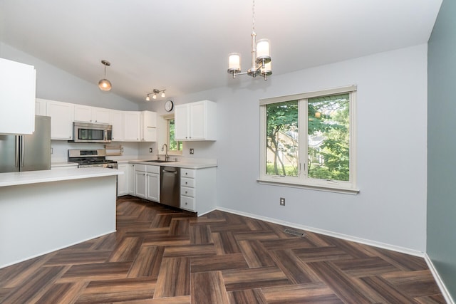 266 Westover Ave, Ann Arbor, MI 48103 - kitchen with appliances with stainless steel finishes, light countertops, lofted ceiling, a chandelier, and white cabinetry