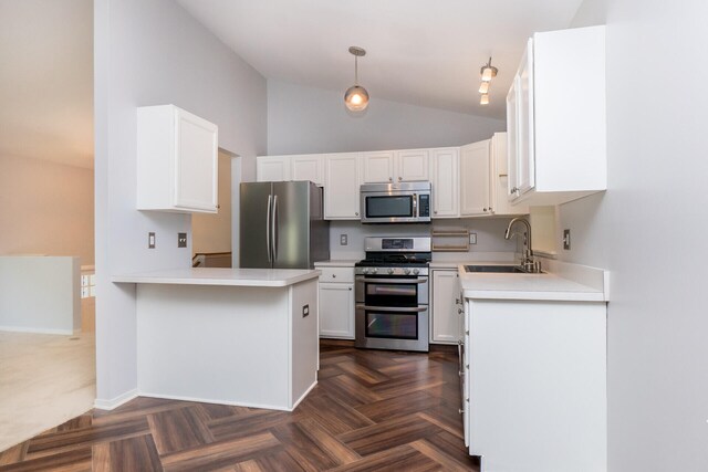 266 Westover Ave, Ann Arbor, MI 48103 - kitchen featuring stainless steel appliances, a peninsula, white cabinets, light countertops, and hanging light fixtures