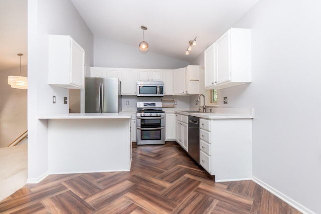 266 Westover Ave, Ann Arbor, MI 48103 - kitchen featuring appliances with stainless steel finishes, lofted ceiling, white cabinetry, light countertops, and a peninsula