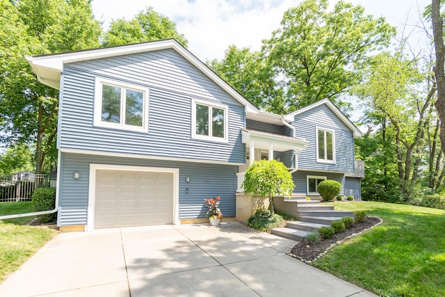 266 Westover Ave, Ann Arbor, MI 48103 - bi-level home featuring concrete driveway, a front yard, and a garage