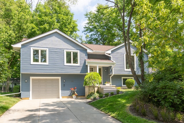 266 Westover Ave, Ann Arbor, MI 48103 - bi-level home featuring concrete driveway, a front lawn, and a garage