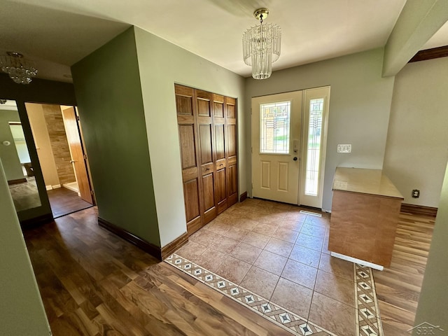 4650 Village Dr, Saginaw, MI 48638 - foyer entrance with a chandelier and tile patterned floors