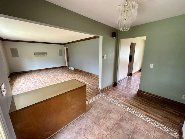 4650 Village Dr, Saginaw, MI 48638 - unfurnished room featuring a chandelier, ornamental molding, and wood finished floors