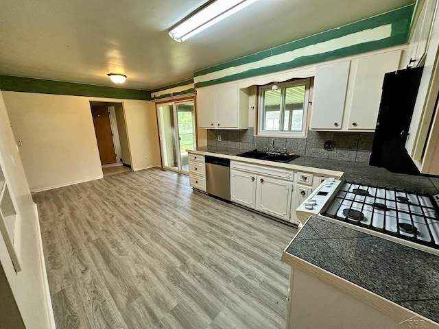 4650 Village Dr, Saginaw, MI 48638 - kitchen with dishwasher, tile counters, white cabinets, decorative backsplash, and light wood-style flooring