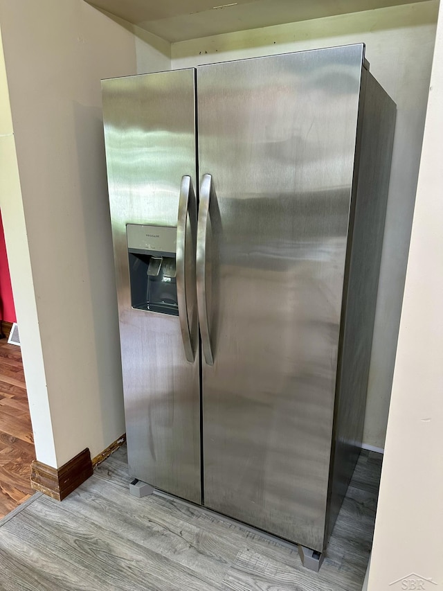 4650 Village Dr, Saginaw, MI 48638 - kitchen view of stainless steel fridge with ice dispenser and wood finished floors