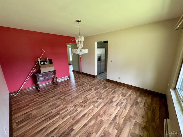 4650 Village Dr, Saginaw, MI 48638 - unfurnished dining area featuring a chandelier and wood finished floors
