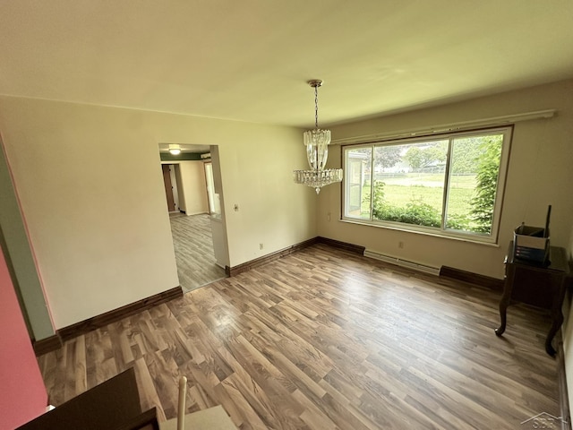 4650 Village Dr, Saginaw, MI 48638 - unfurnished dining area featuring a chandelier, wood finished floors, and a baseboard heating unit