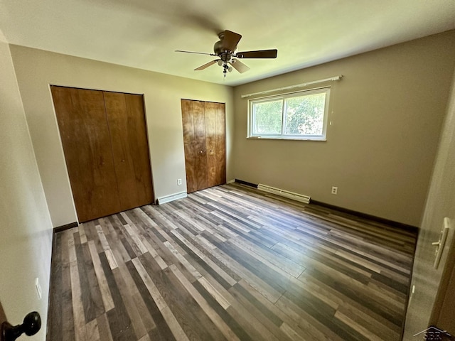 4650 Village Dr, Saginaw, MI 48638 - unfurnished bedroom featuring multiple closets, wood finished floors, a baseboard radiator, and ceiling fan
