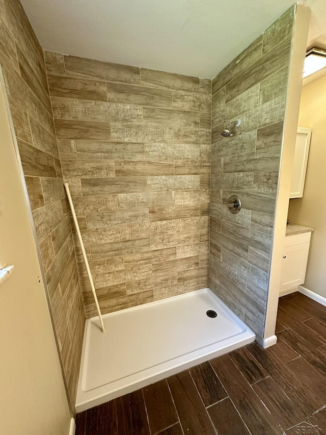 4650 Village Dr, Saginaw, MI 48638 - full bath with tiled shower, wood finish floors, and vanity