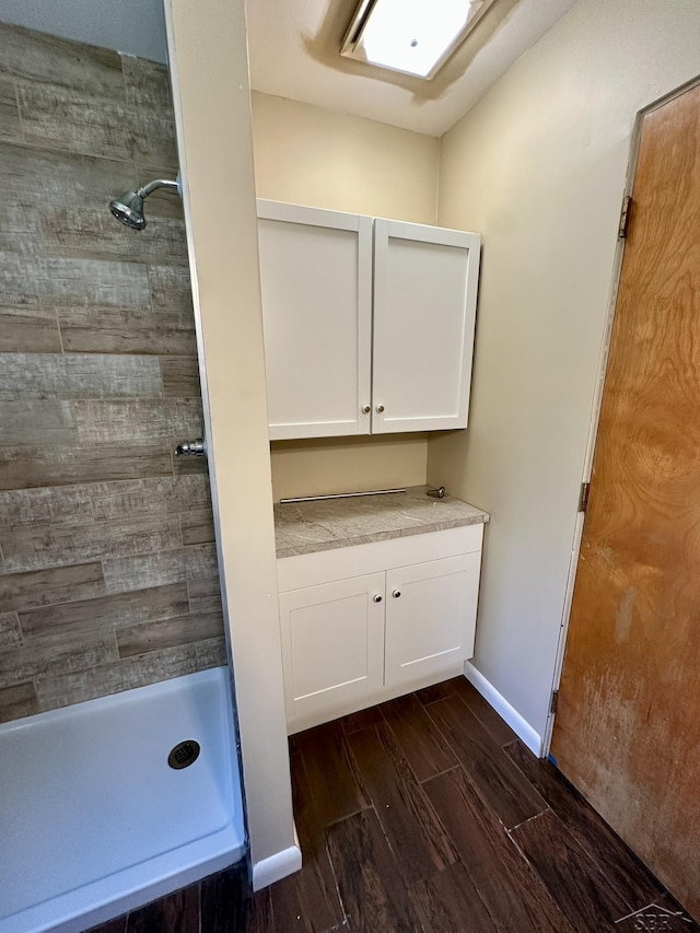 4650 Village Dr, Saginaw, MI 48638 - full bathroom featuring wood tiled floors, tiled shower, and vanity