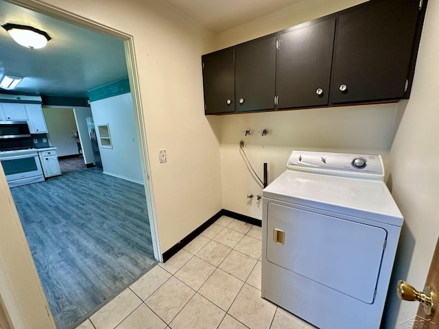 4650 Village Dr, Saginaw, MI 48638 - laundry room with washer / dryer, cabinet space, and light tile patterned floors