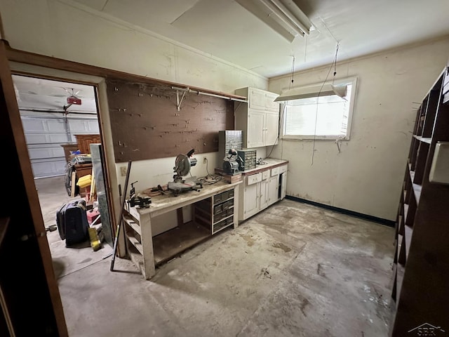 4650 Village Dr, Saginaw, MI 48638 - kitchen featuring unfinished concrete floors, white cabinetry, light countertops, and freestanding refrigerator