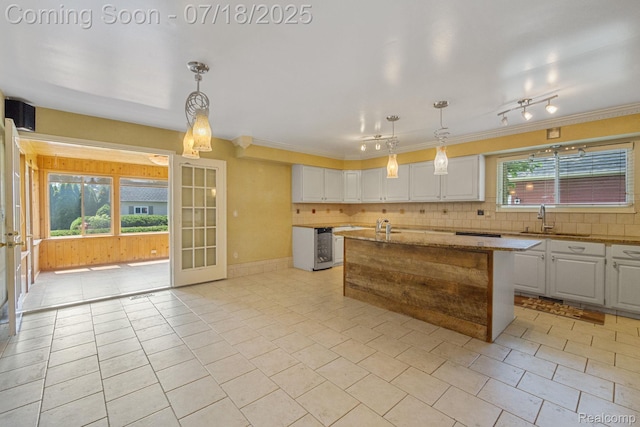 8400 Oak Shade Ct, Davison, MI 48423 - kitchen featuring white cabinets, decorative backsplash, ornamental molding, light tile patterned floors, and light stone countertops