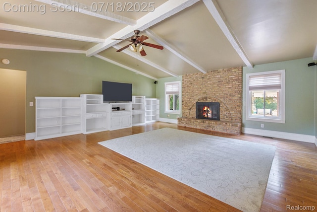 8400 Oak Shade Ct, Davison, MI 48423 - unfurnished living room with wood-type flooring, a brick fireplace, and ceiling fan