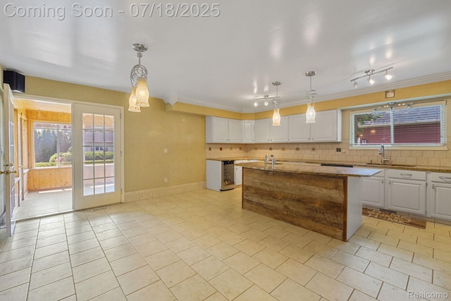 8400 Oak Shade Ct, Davison, MI 48423 - kitchen featuring white cabinets, light tile patterned floors, backsplash, light stone counters, and ornamental molding