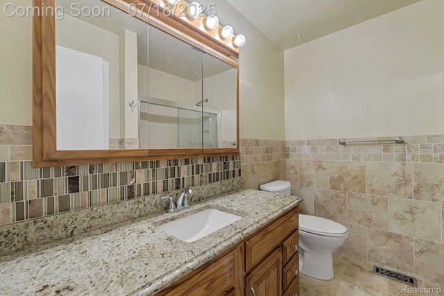 8400 Oak Shade Ct, Davison, MI 48423 - bathroom with a stall shower, vanity, tile walls, and a wainscoted wall