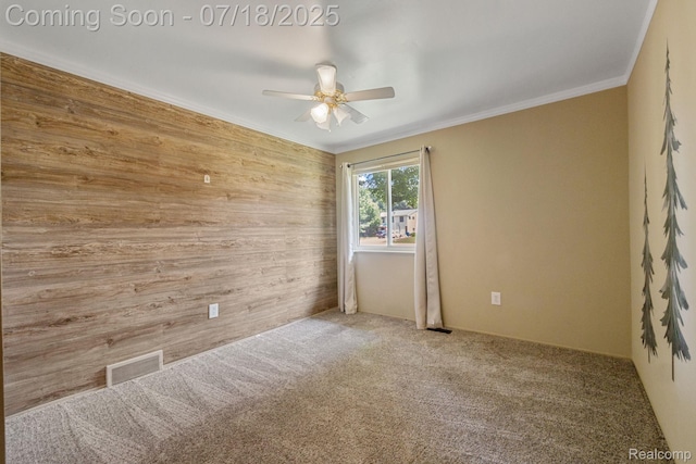 8400 Oak Shade Ct, Davison, MI 48423 - carpeted empty room featuring wooden walls, a ceiling fan, and crown molding