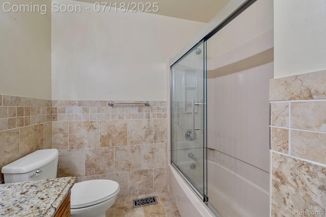 8400 Oak Shade Ct, Davison, MI 48423 - full bathroom featuring tile walls, vanity, enclosed tub / shower combo, and a wainscoted wall