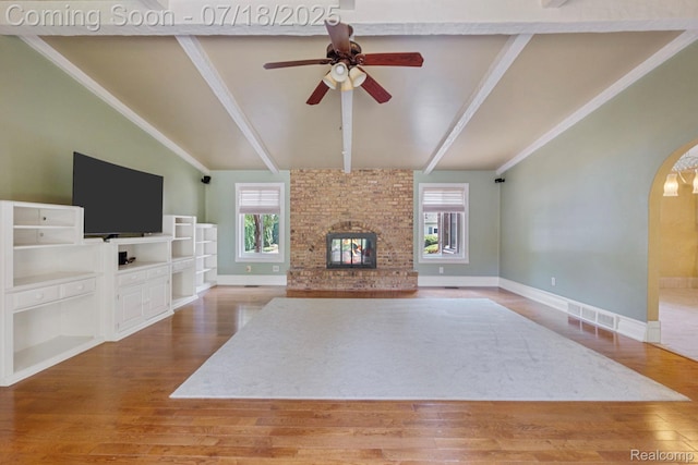 8400 Oak Shade Ct, Davison, MI 48423 - unfurnished living room featuring plenty of natural light, ceiling fan, a fireplace, and wood finished floors