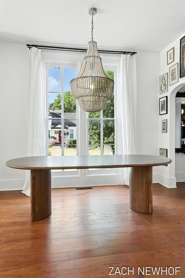 334 Washington Blvd, Holland, MI 49423 - unfurnished dining area featuring healthy amount of natural light, arched walkways, and dark wood-type flooring