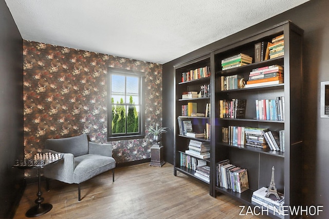 334 Washington Blvd, Holland, MI 49423 - sitting room with wallpapered walls, wood finished floors, and a textured ceiling