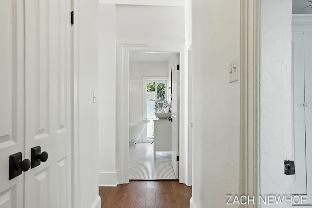 334 Washington Blvd, Holland, MI 49423 - corridor featuring dark wood-type flooring and baseboards