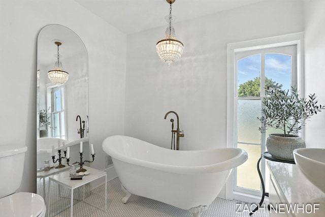 334 Washington Blvd, Holland, MI 49423 - bathroom with a freestanding tub, tile patterned flooring, and a chandelier