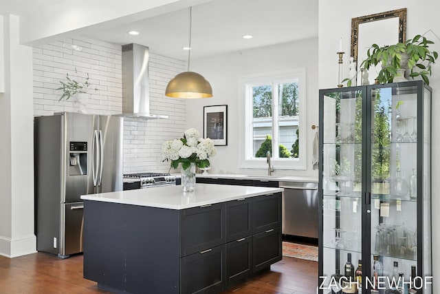 334 Washington Blvd, Holland, MI 49423 - kitchen with stainless steel appliances, wall chimney exhaust hood, dark wood-style flooring, light countertops, and decorative backsplash