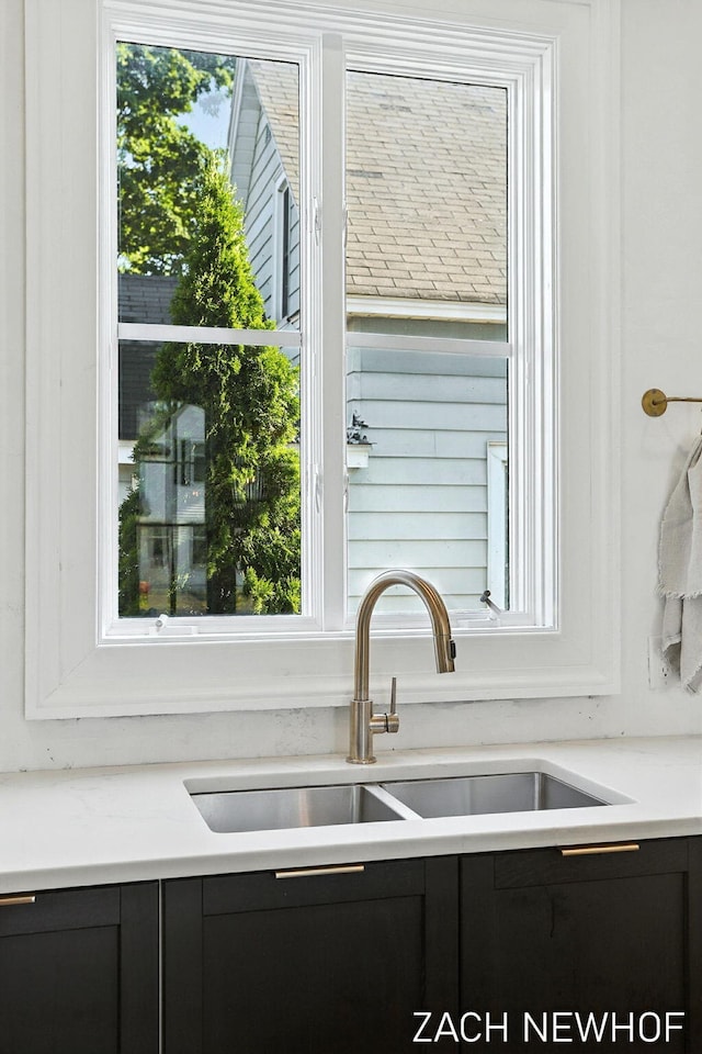 334 Washington Blvd, Holland, MI 49423 - kitchen featuring dark cabinetry and light countertops