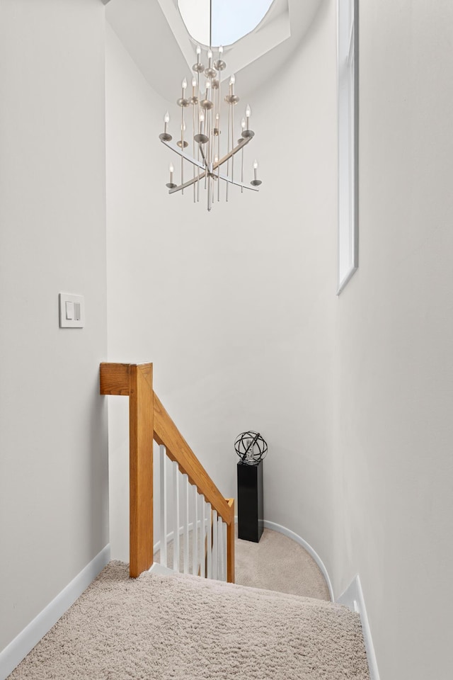 2323 Solano Dr, Wolverine Lake, MI 48390 - staircase with carpet flooring and a chandelier