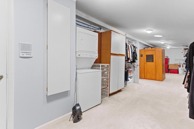 2323 Solano Dr, Wolverine Lake, MI 48390 - laundry room featuring estacked washer and dryer, light colored carpet, and crown molding