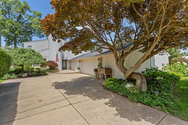 2323 Solano Dr, Wolverine Lake, MI 48390 - view of home's exterior featuring an attached garage and concrete driveway