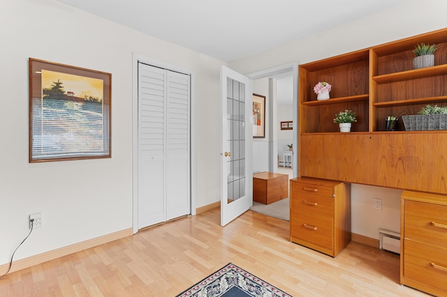 2323 Solano Dr, Wolverine Lake, MI 48390 - unfurnished office featuring light wood-style floors, french doors, and a baseboard heating unit