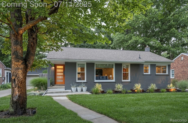 4412 Buckingham Rd, Royal Oak, MI 48073 - view of front of home with a front lawn, covered porch, a chimney, brick siding, and roof with shingles